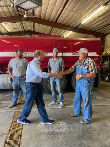 Governor Polis shaking hands with first responders. 